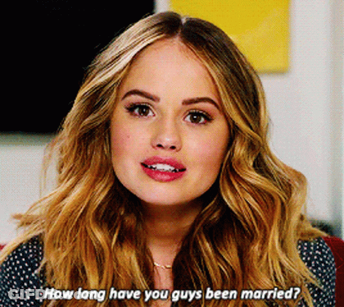 A Woman With Long Blonde Hair Is Asking How Long Have You Guys Been Married GIF