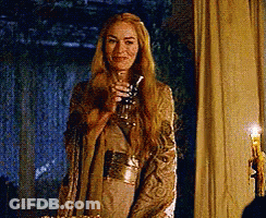 A Woman With Long Blonde Hair Is Holding A Glass In Her Hand . GIF