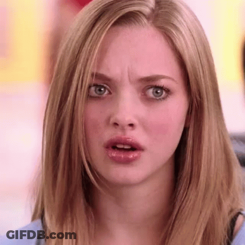 A Woman With Long Blonde Hair Is Making A Surprised Face . GIF