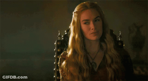 A Woman With Long Blonde Hair Is Sitting In A Chair GIF