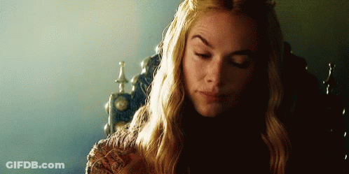 A Woman With Long Blonde Hair Is Sitting In A Chair With Her Eyes Closed And A Crown On Her Head . GIF