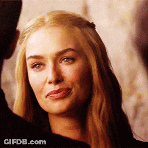 A Woman With Long Blonde Hair Is Smiling And Looking At The Camera GIF