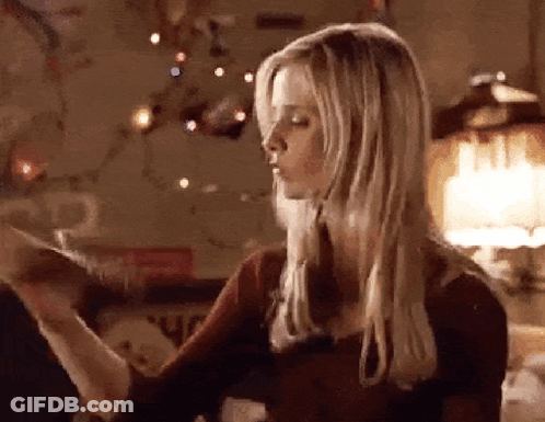Woman With Blonde Hair Standing By Christmas Tree GIF