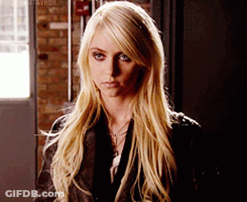 A Woman With Long Blonde Hair Is Wearing A Black Leather Jacket GIF
