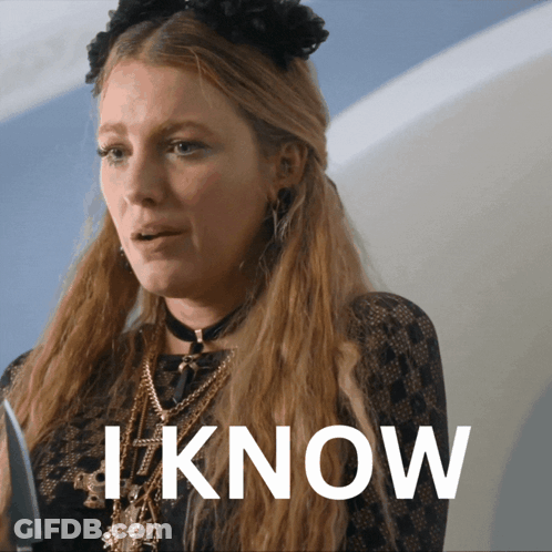 A Woman With Long Blonde Hair Is Wearing A Choker And Necklaces And The Word I Know Is Behind Her GIF