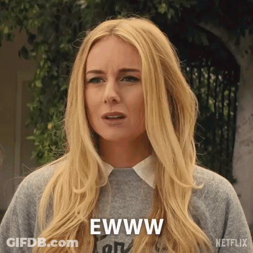 A Woman With Long Blonde Hair Is Wearing A Gray Sweater And Says Ewww GIF
