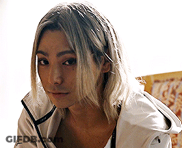 A Woman With Long Blonde Hair Wearing A White Jacket GIF