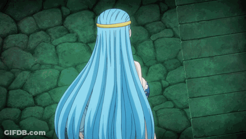 A Woman With Long Blue Hair Stands In Front Of A Green Wall GIF