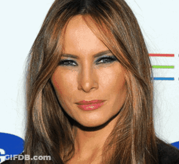 A Woman With Long Brown Hair And Blue Eyeshadow GIF