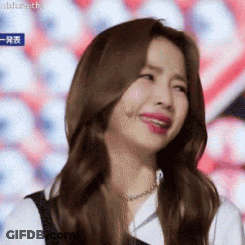 A Woman With Long Brown Hair Is Making A Funny Face With Her Mouth Open . GIF