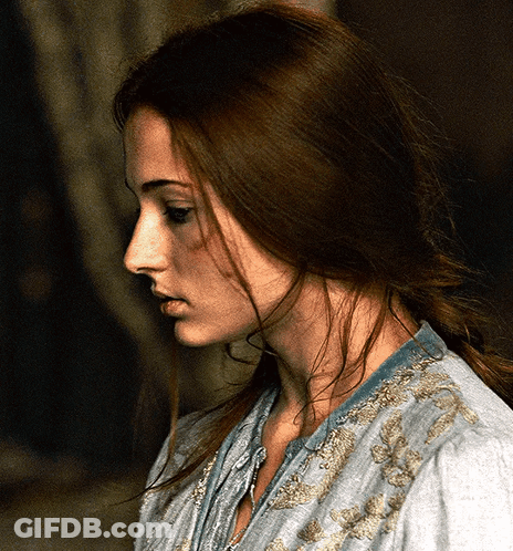 A Woman With Long Brown Hair Is Wearing A Blue Shirt GIF