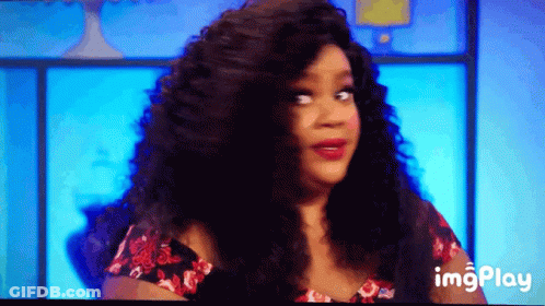 A Woman With Long Curly Hair Is On A Television Screen With A Blue Background And The Words Imgplay Below Her GIF