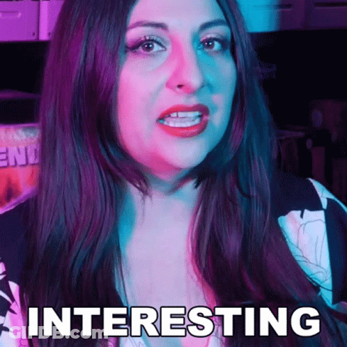 A Woman With Long Dark Hair Is Making A Funny Face And The Word Interesting Is On Her Face . GIF