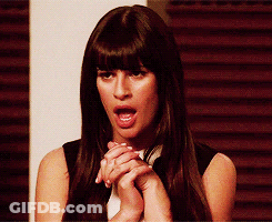 A Woman With Long Dark Hair Is Making A Funny Face GIF