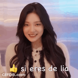 A Woman With Long Dark Hair Is Smiling And Giving A Thumbs Up Sign . GIF
