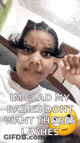 A Woman With Long Eyelashes Is Making A Funny Face And Holding A Smiley Face . GIF
