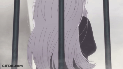 A Woman With Long Gray Hair Behind Bars GIF