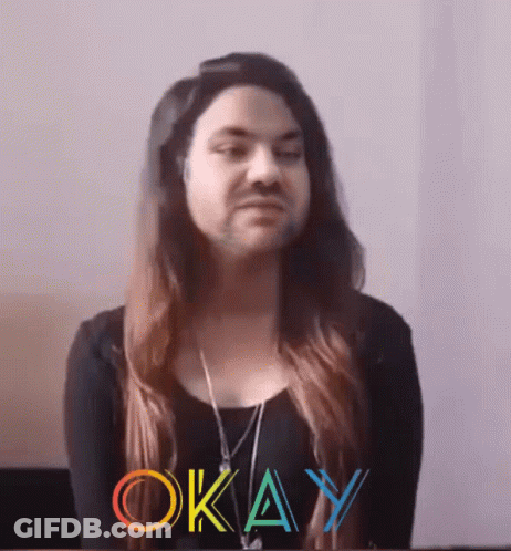 A Woman With Long Hair And A Beard Has The Word Okay Written On Her Face GIF