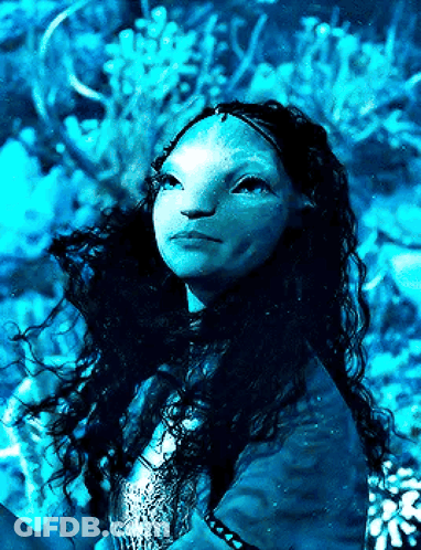 A Woman With Long Hair And A Blue Face Is Looking Up At The Sky GIF