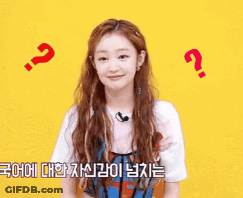 A Woman With Long Hair And A Microphone Is Surrounded By Question Marks And A Foreign Language . GIF