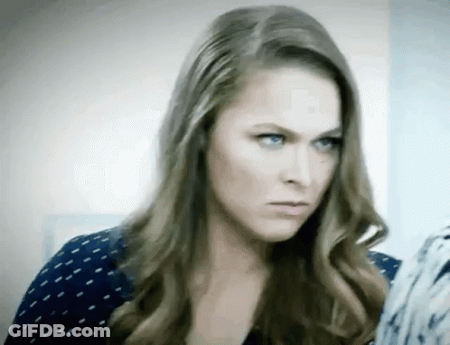 A Woman With Long Hair And Blue Eyes Is Making A Serious Face . GIF