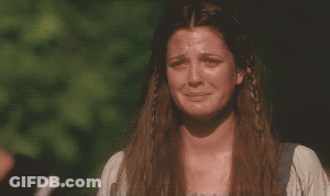 A Woman With Long Hair And Braids Is Crying GIF