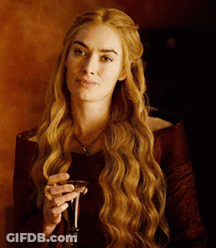A Woman With Long Hair Is Holding A Glass Of Wine GIF
