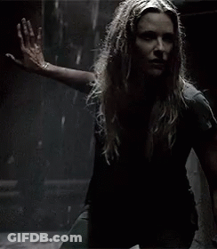 A Woman With Long Hair Is Holding A Knife In Her Hand . GIF