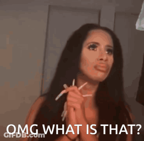 A Woman With Long Hair Is Holding A Pair Of Pencils In Her Hands And Says OMG What Is That GIF
