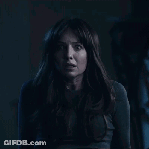 A Woman With Long Hair Is Looking At The Camera With A Shocked Look On Her Face GIF