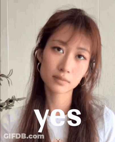 A Woman With Long Hair Is Looking At The Camera With The Word Yes In Front Of Her GIF