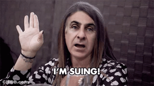 A Woman With Long Hair Is Making A Funny Face And Saying `` I 'M Suing ! '' GIF