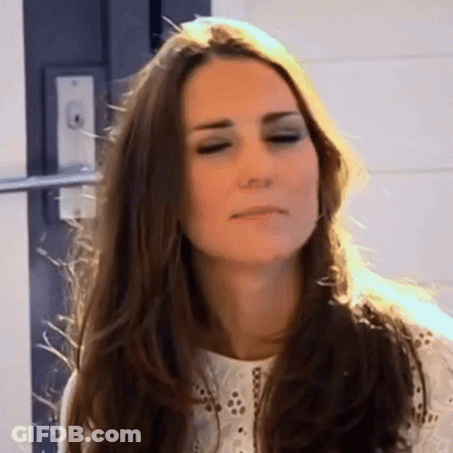 A Woman With Long Hair Is Making A Funny Face . GIF