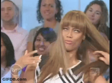 A Woman With Long Hair Is Making A Funny Face In Front Of A Group Of People With A Tnt Logo In The Corner GIF