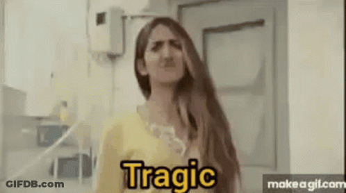 A Woman With Long Hair Is Making A Funny Face While Standing In Front Of A Door . GIF