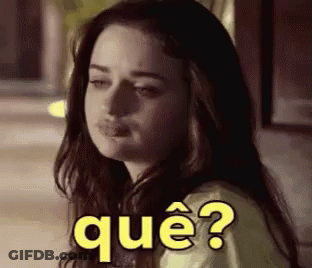 A Woman With Long Hair Is Making A Funny Face With The Words Que ? Written On Her Face . GIF