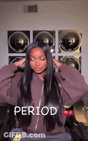 A Woman With Long Hair Is Sitting In Front Of A Washing Machine With The Word Period Written On The Bottom GIF