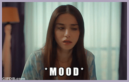 A Woman With Long Hair Is Sitting In Front Of A Window With The Words * Mood * Written On The Bottom GIF