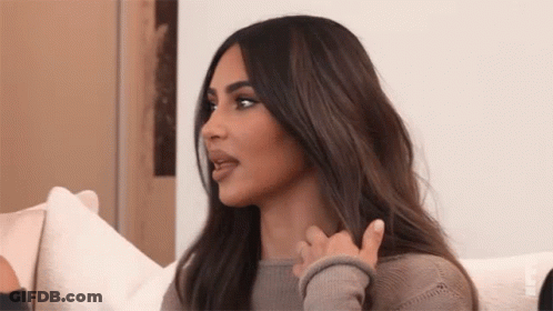 A Woman With Long Hair Is Sitting On A Couch And Talking To Another Woman . GIF