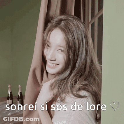 A Woman With Long Hair Is Smiling With The Words Sonrei Si Sos De Lore Behind Her GIF