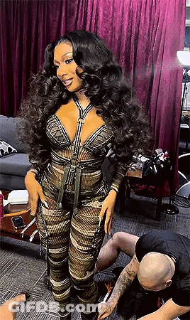 A Woman With Long Hair Is Standing Next To A Man In A Tattoo Studio . GIF