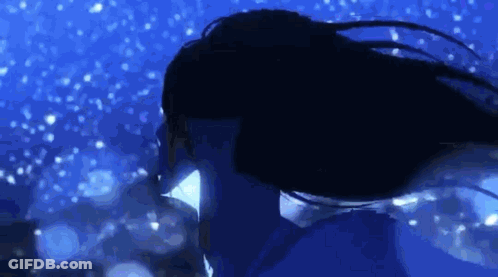 A Woman With Long Hair Is Swimming In The Water At Night . GIF