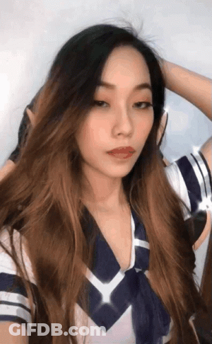 A Woman With Long Hair Is Wearing A Blue And White Sailor Outfit GIF
