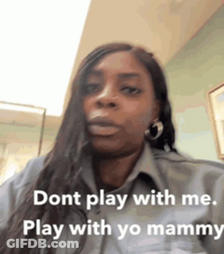 A Woman With Long Hair Is Wearing A Grey Shirt And Earrings And Says Dont Play With Me Play With Yo Mammy . GIF