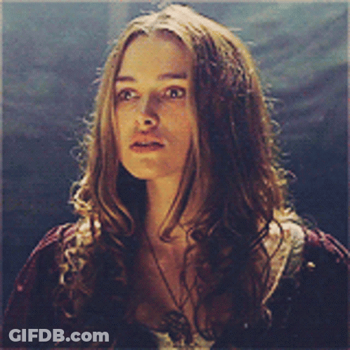 A Woman With Long Hair Is Wearing A Necklace And A Red Shirt GIF