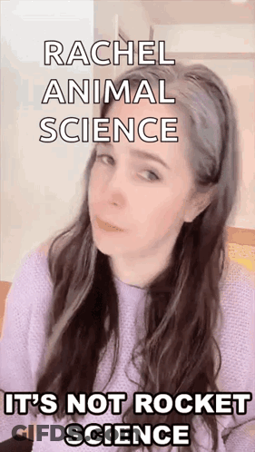 A Woman With Long Hair Is Wearing A Purple Sweater And Making A Funny Face While Talking About Animal Science GIF