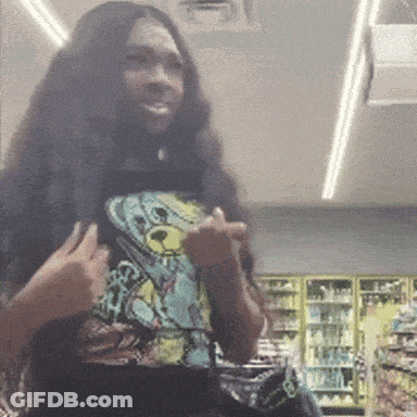 A Woman With Long Hair Is Wearing A Teddy Bear Shirt And Giving The Middle Finger GIF