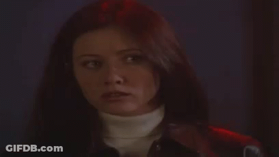 A Woman With Long Hair Is Wearing A Turtleneck And A Leather Jacket . GIF