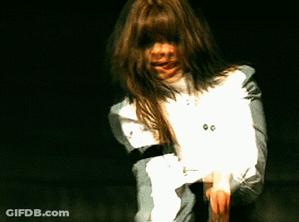 A Woman With Long Hair Is Wearing A White Shirt With The Number 00 On The Front GIF
