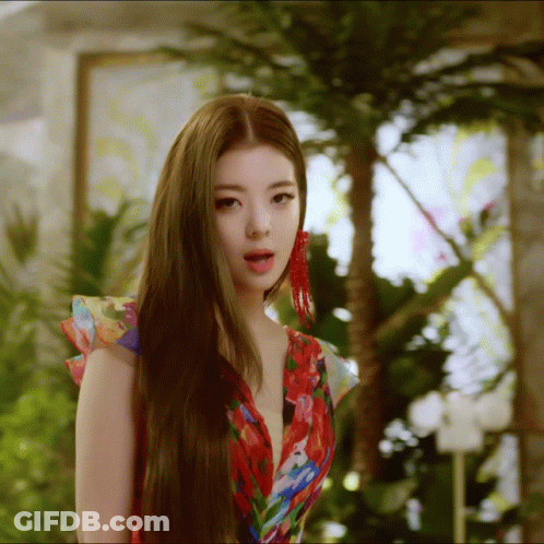 A Woman With Long Hair Wearing A Floral Dress GIF